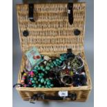 Small wicker picnic basket containing various costume jewellery, dress rings, necklaces,