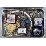 Quimperware-style French tin box to include filigree brooch and other brooches in delft style,