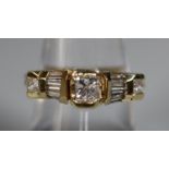 14ct gold Modernist style diamond ring of brilliant cut and baguette cut diamonds. Ring size N&1/