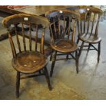 Set of three early 20th century elm and beech spindle back farmhouse chairs on moulded circular