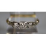 Yellow metal three stone diamond ring. Ring size R. Approx weight 3.5 grams. (B.P. 21% + VAT)