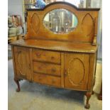 Early 20th century mahogany bow front, mirror back sideboard on carved ball and claw feet. (B.P. 21%