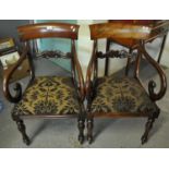 Pair of William IV mahogany scroll armed side chairs with upholstered seats on vase shaped legs. (2)