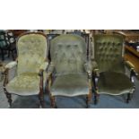 Three similar Victorian button back upholstered fireside armchairs, all standing on baluster