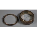 Wide silver engraved bangle and a narrow plain silver bangle. (B.P. 21% + VAT)