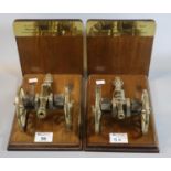 Pair of brass mounted wooden bookends each having a brass scale model of a 9 pound field piece Royal