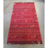 Red and pink ground geometric kelim runner. (B.P. 21% + VAT)