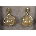 A pair of Clogau 9ct gold earrings set with rutilated quartz and diamonds. Approx weight 4.1