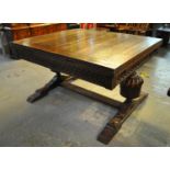 Early 20th Century oak draw leaf dining table, the moulded top above carved frieze panels, large