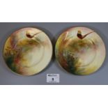 Pair of Royal Worcester porcelain side plates hand painted with pheasants amongst foliage, signed