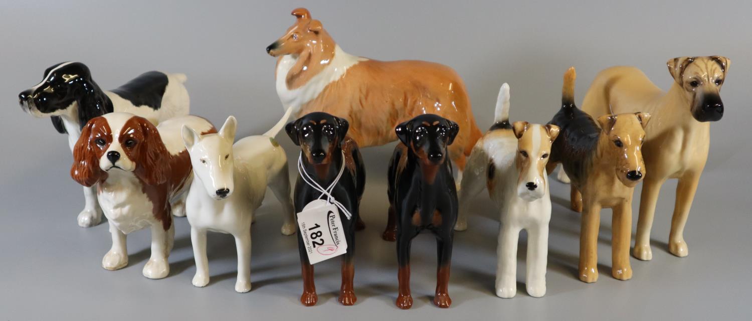 Beswick - a collection of nine dog figures to include; 'Cast iron Monarch' and 'Talavera Romulus