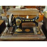 Vintage Jones sewing machine with fitted hood. (B.P. 21% + VAT)