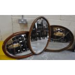 Three Edwardian oval bevel plate mirrors with oak and mahogany frames. (3) (B.P. 21% + VAT)