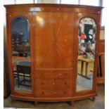 Edwardian satinwood and mahogany bow front double mirrored wardrobe, together with matching double
