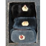 Box containing three Russian faux fur hats with military crests with reproduction soviet badges. (