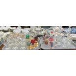 Two trays of assorted glassware to include; cut and plain glass decanters with stoppers, scent