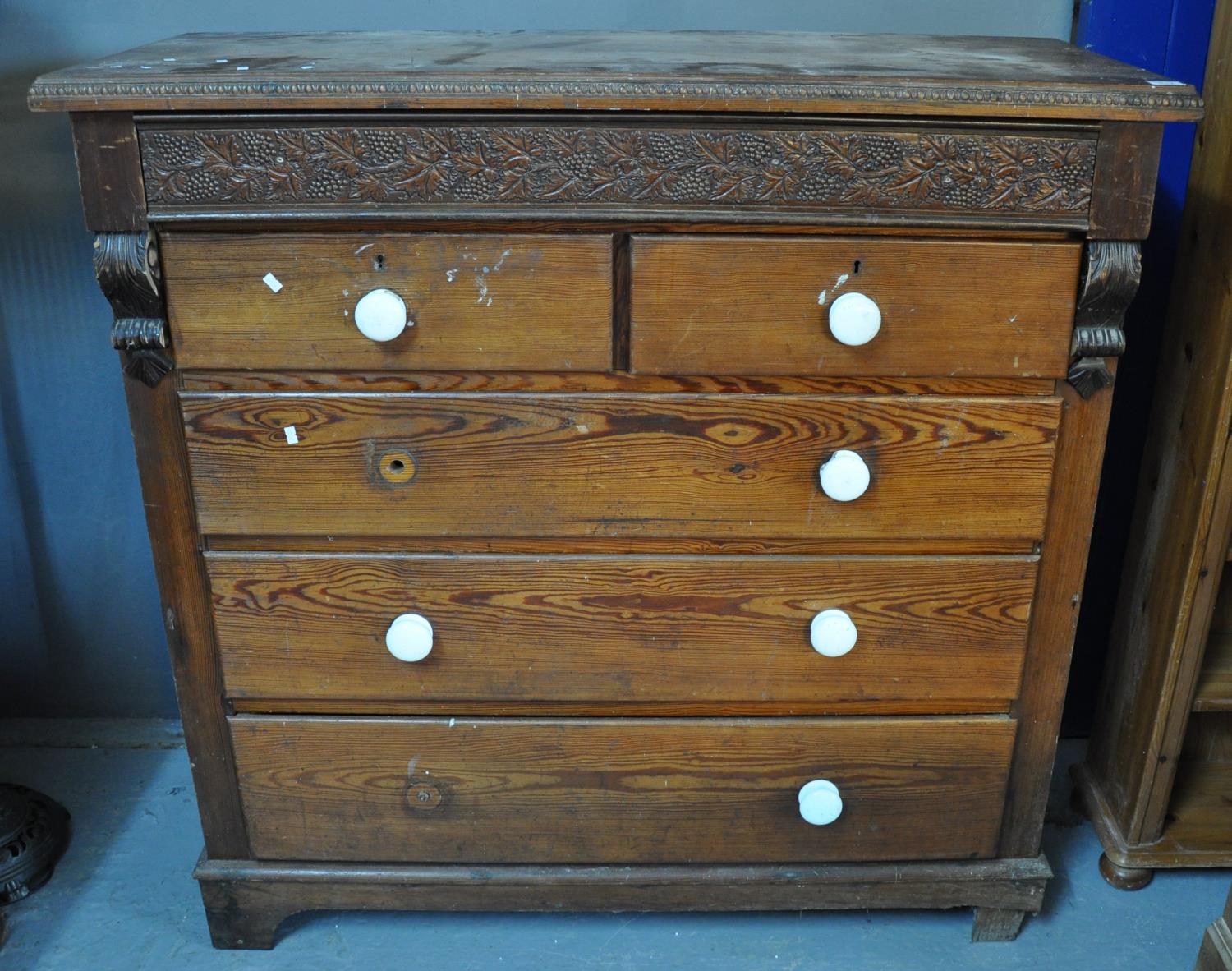 Victorian pitch pine straight front chest of two short and three long drawers with carved berry