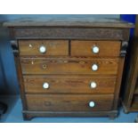 Victorian pitch pine straight front chest of two short and three long drawers with carved berry