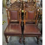 A pair of four late Victorian oak dining chairs having carved stylised dragon decoration on fluted