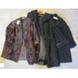 Two vintage black Astrakhan fur coats, a calf skin coat with Astrakhan collar and two mouton or