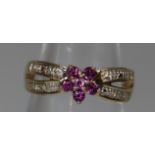 Yellow metal cluster ring set with pink stones with split diamond set shoulders. Ring size J. Approx