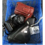 Box containing two cameras; one cased, one in associate case and a leather camera bag to include;