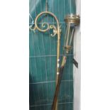 Ecclesiastical brass candle holder on turned wooden staff, together with a brass bishop's crozier or