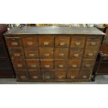 Early 20th Century pine pharmacy bank of 24 drawers with labels including; bandages, disposable