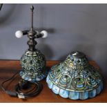 Tiffany style table lamp on a blue ground with abstract decoration. (B.P. 21% + VAT)