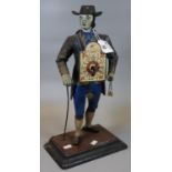 Painted spelter clock in the form of a Dutch clock seller on rectangular base. 39.5cm high