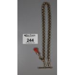 Yellow metal chain with T bar and clasped hand pendant. Approx weight 11.9 grams. (Tests as 9ct