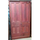 Late 19th/early 20th Century painted pine two door school cupboard of narrow proportions, the