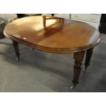 Victorian mahogany extending dining table on fluted tapering legs, cups and ceramic casters. (B.P.