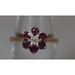 9ct gold ruby and diamond flowerhead cluster ring. Ring size N. Approx weight 2.6 grams. (B.P. 21% +