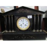 Large black slate gilt decorated architectural two train mantel clock with enamelled Roman face. (