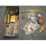 Tin tub of oddments to include magnifying glass, badges, brass vestas marked France. (B.P. 21% +