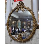 Gilt metal framed mirror with foliate design and ribbon mount. (B.P. 21 + VAT)