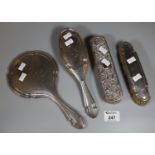 Bag of silver vanity items to include hand mirror and three brushes, one with floral and foliate