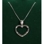 9ct white gold heart pendant on chain set with diamonds. Approx weight 1.6 grams. (B.P. 21% + VAT)