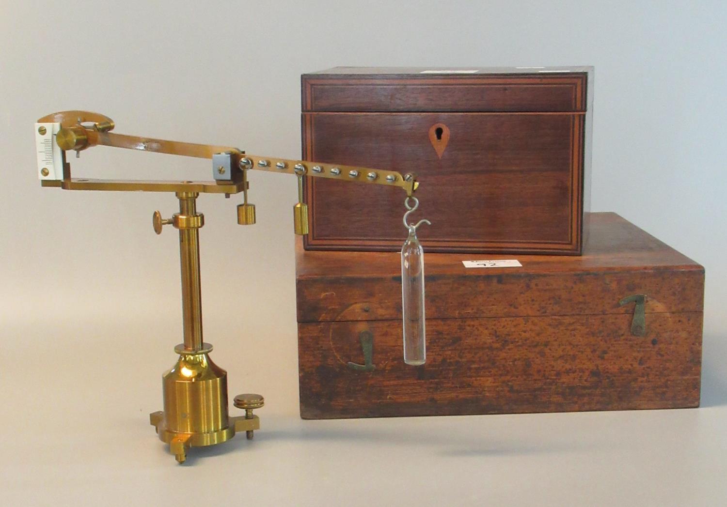 Gilded brass Westphal scientific balance with weights and accessories in a fitted wooden box.