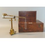 Gilded brass Westphal scientific balance with weights and accessories in a fitted wooden box.