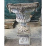 Modern composition urn-shaped fluted classical design planter with loop handles, standing on a