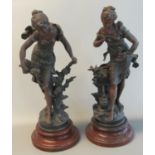 Pair of French bronzed spelter emblematic figures on circular bases. 54 cm high approx. (2) (B.P.