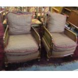 Pair of early 20th century walnut single cane bergere armchairs on cabriole legs and pad feet. (