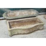 Two modern composite planters of oval and serpentine form. 90 cm & 74 cm length approx. (2) (B.P.