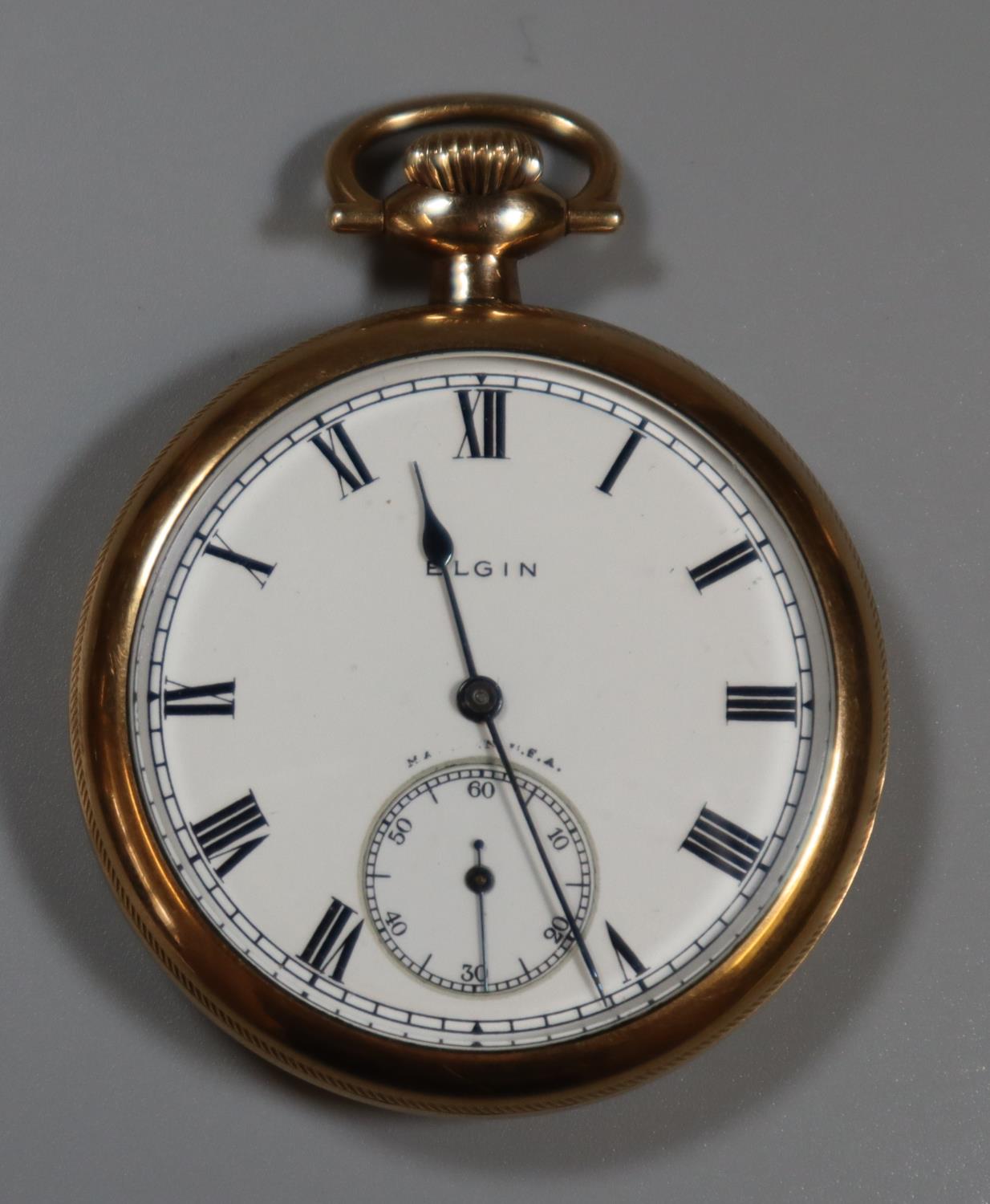 Elgin gold plated open faced pocket watch with enamel face and Roman numerals with engraved chased