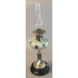 Early 20th century brass double burner oil lamp with painted ceramic reservoir, brass column, and