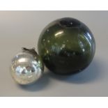 Coloured glass fishing float with liquid contents, together with a small silvered watch or witch