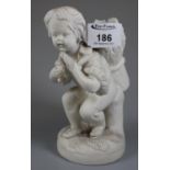 Parian ware figure of a young boy holding a basket with wheat over his shoulder. Possibly a spill