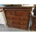 Victorian oak straight front chest with two short and three long drawers, flanked by carved